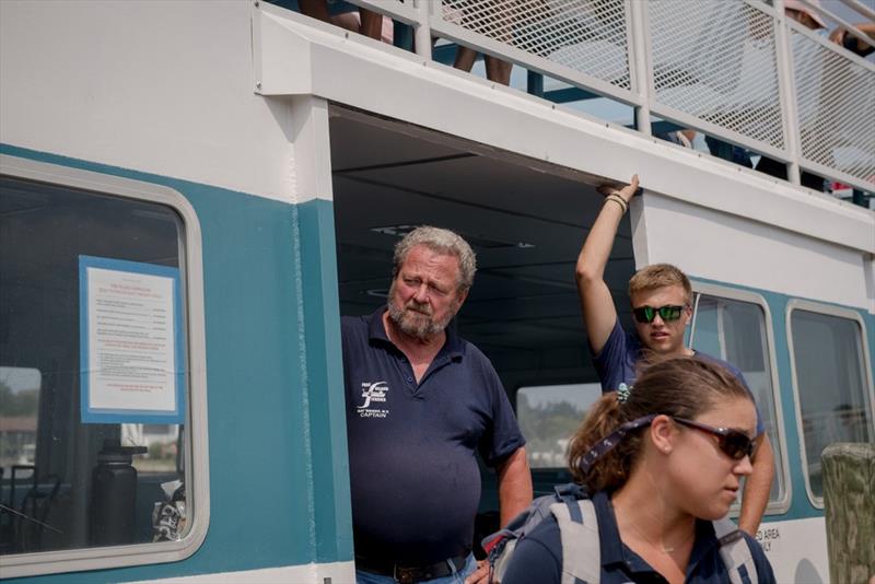 Capt. Ernie Villing watched with Dylan Molnar, an 18-year-old deckhand with Fire Island Ferries, as passengers and luggage filled the Fire Island Belle in August photo copyright Hilary Swift for The New York Times taken at  and featuring the Power boat class