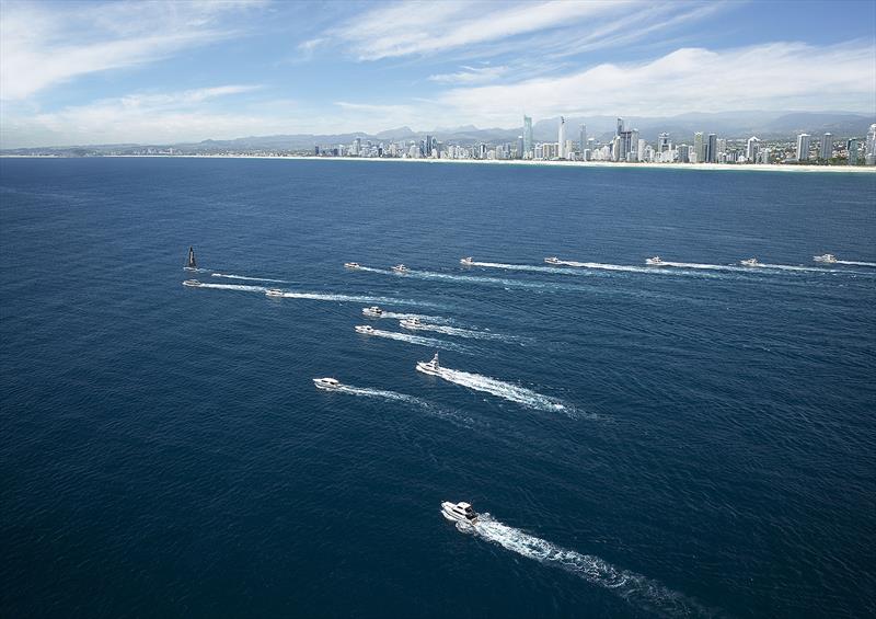 The fleet shadows USA 16 as she hoists her sails off the Gold Coast photo copyright Maritimo taken at  and featuring the Power boat class