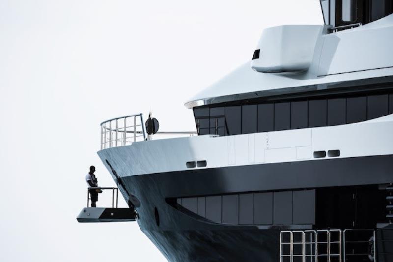 91,5 metres megayacht Tranquility at the anchor in a Med bay. One of her crew controlling the helm from the outside photo copyright Guillaume Plisson taken at  and featuring the Power boat class