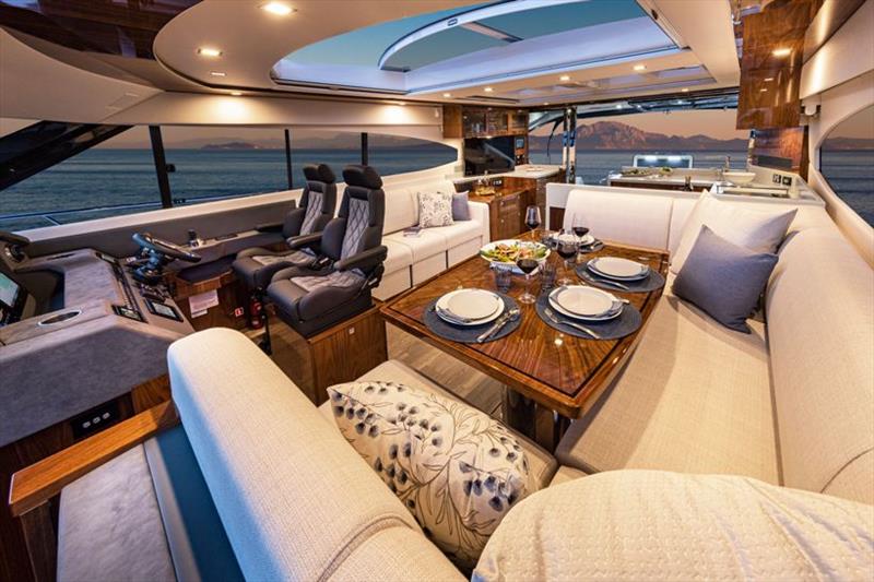 Glass skylights illuminate the aft galley area of the Riviera 6000 Sport Yacht, and a sunroof provides light and air to the dining area, lounge and helm forward. - photo © Riviera Australia