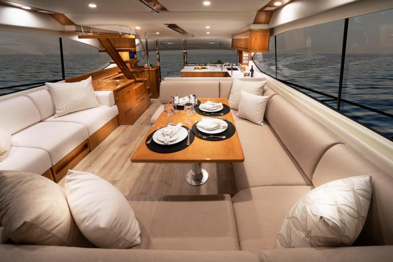 The luxurious saloon with U-shape aft galley and forward lounge and dining area aboard the Riviera 54 Enclosed Flybridge. - photo © Riviera Australia
