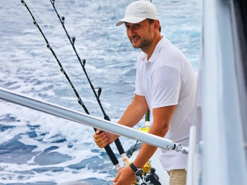 Captain Yury Istomin adjusts the lines aboard his highly customised Riviera 52 Enclosed Flybridge photo copyright Riviera Australia taken at  and featuring the Power boat class