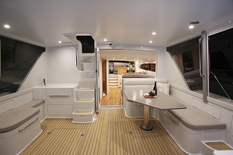 Cockpit, exterior mid-pilothouse stairs, exterior dinette. Note: the window between the dinettes is electrically actuated with the bi-fold cockpit doors sealing directly against the glass when in the closed position - B63 photo copyright Lloyd Stevenson Boatbuilders taken at  and featuring the Power boat class