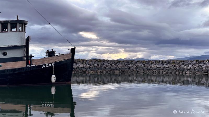 Sun setting behind Adak, Heritage Harbor photo copyright Laura Domela taken at  and featuring the Power boat class