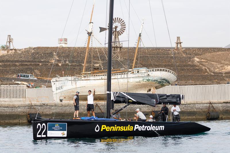 Peninsula Petroleum owner John Bassadone waves from the bow as the teams return to Marina Lanzarote to await further instructions on day 3 of the RC44 Calero Marinas Cup photo copyright Martinez Studio / RC44 Class taken at  and featuring the RC44 class