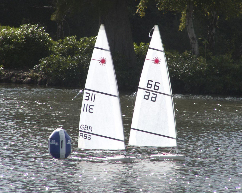 John Tushingham (311) and Andy Kissick (66) at the wing mark during the Yately RC Laser open photo copyright RC Laser Class Association taken at  and featuring the RC Laser class