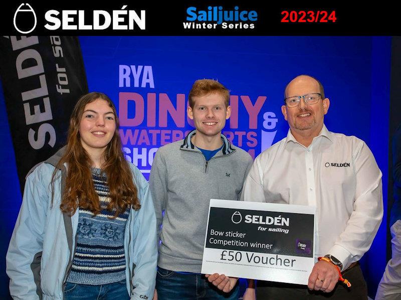 Ben Dearden and Alice Carter win the sticker competition - Prizegiving for the Seldén Sailjuice Winter Series 2023/24 photo copyright Tim Olin / www.olinphoto.co.uk taken at RYA Dinghy Show and featuring the RS200 class
