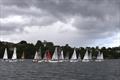 Sabot fleet racing – spark sails red (Meg Ellis); orange (Zach Tait) © Sam Gong