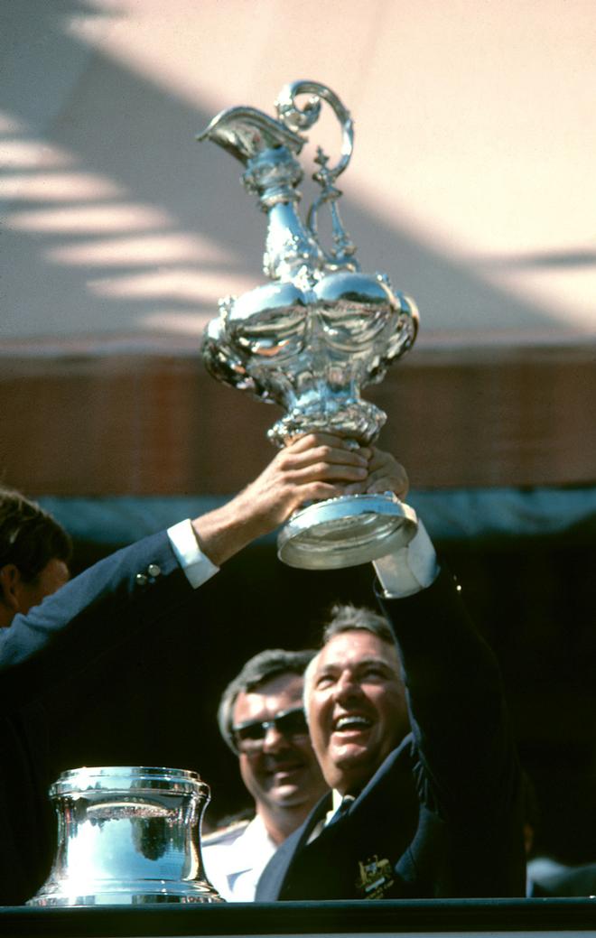 1983 America’s Cup, Newport Rhode Island. Alan Bond holds up the America’s Cup after his 12 metre yacht ’Australia II’ beat the Dennis Conner skippered American defender ’Liberty’ 4:3 © PPL Media http://www.pplmedia.com