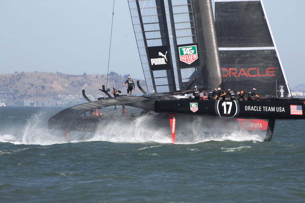 The daggerboards throw up an incredible amount of spray as Oracle continues their gybe. - America’s Cup © Chuck Lantz http://www.ChuckLantz.com