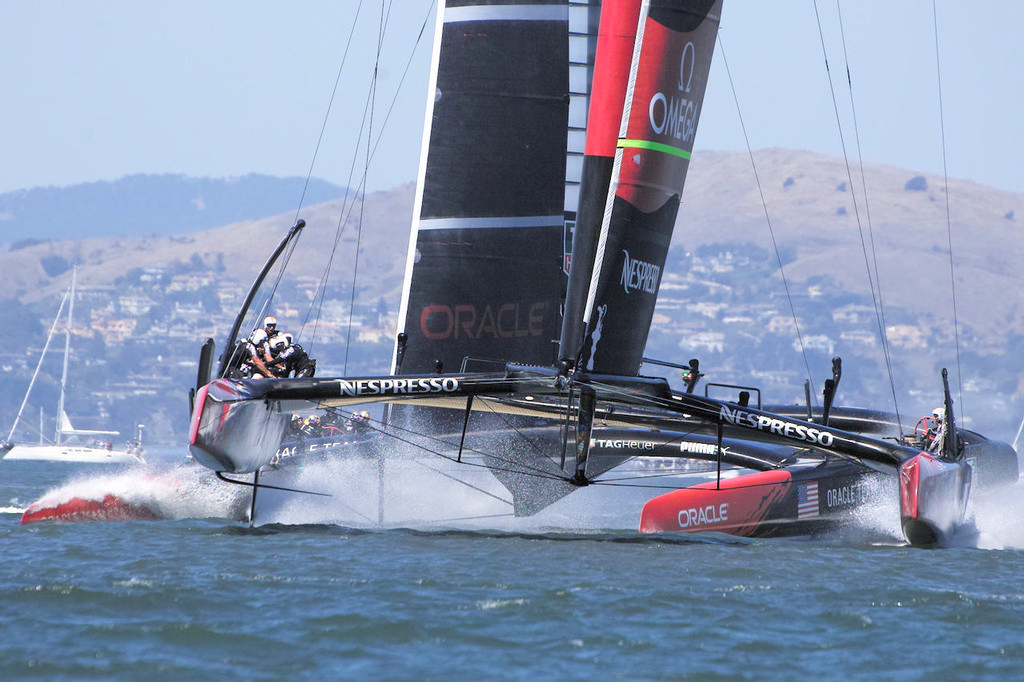 Emirates TNZ lifts onto their foils as Oracle takes a short nose dive before the first mark. - America’s Cup © Chuck Lantz http://www.ChuckLantz.com