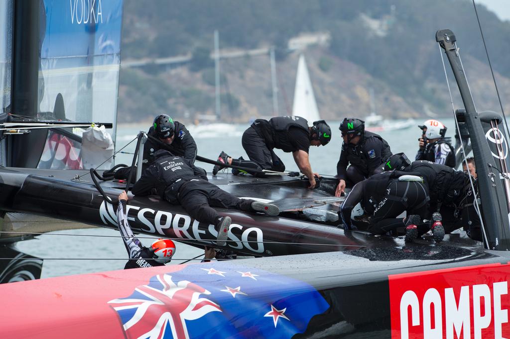 Emirates Team New Zealand remove the fairing broken at the top mark bear away in their first race of the Louis Vuitton finals against Luna Rossa Challenge. .17/8/2013 © Chris Cameron/ETNZ http://www.chriscameron.co.nz