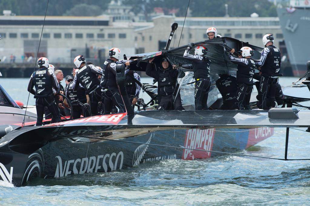 Emirates Team New Zealand remove the fairing broken at the top mark bear away in their first race of the Louis Vuitton finals against Luna Rossa Challenge. .17/8/2013 © Chris Cameron/ETNZ http://www.chriscameron.co.nz