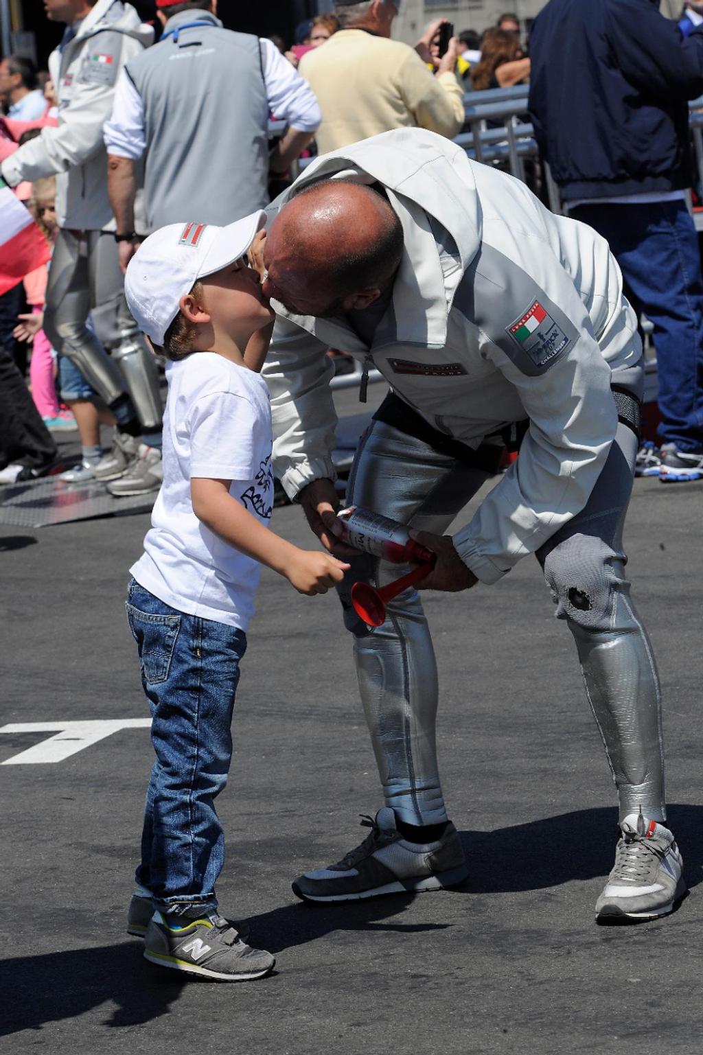 Skipper Max Sirena gives his son Lorenzo, 4, a kiss good-bye before going out to sail in the Louis Vuitton Cup on August 21, 2013 in San Francisco California. photo copyright  SW taken at  and featuring the  class