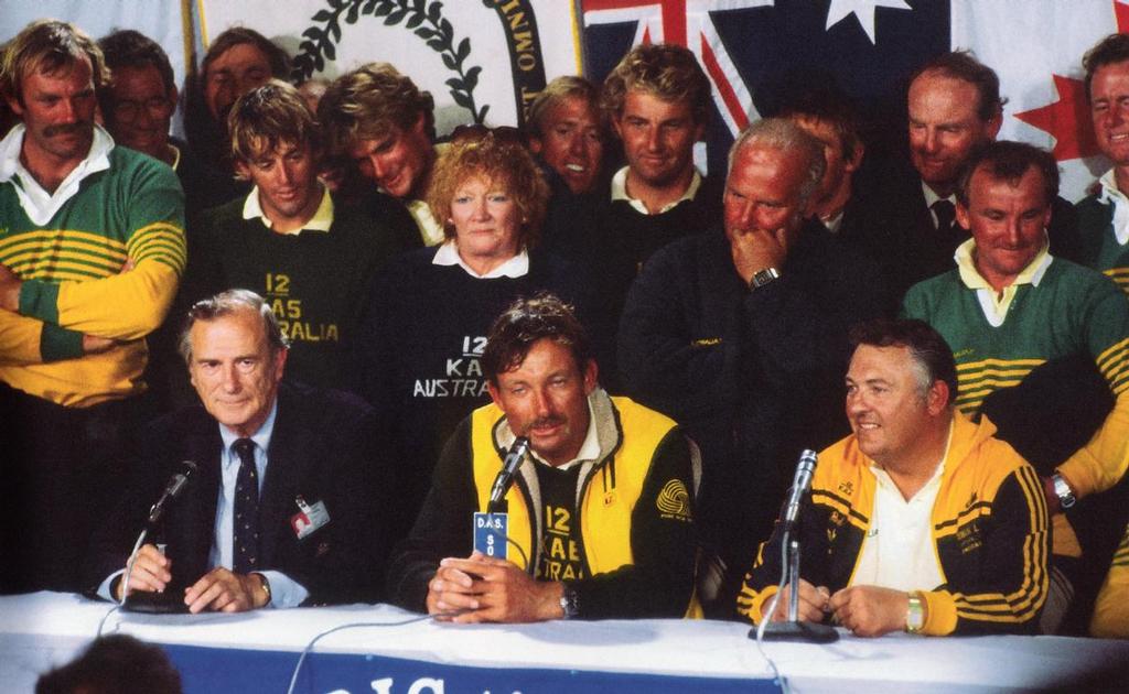 Alan Bond (right), skipper John Bertrand (centre) and a po-faced US Press Officer at the final media conference. Grant Simmer to the immediate left of Eileen Bond at the Media Conference in the State Armoury, following Australia II, s win in 1983. - photo © Paul Darling Photography Maritime Productions