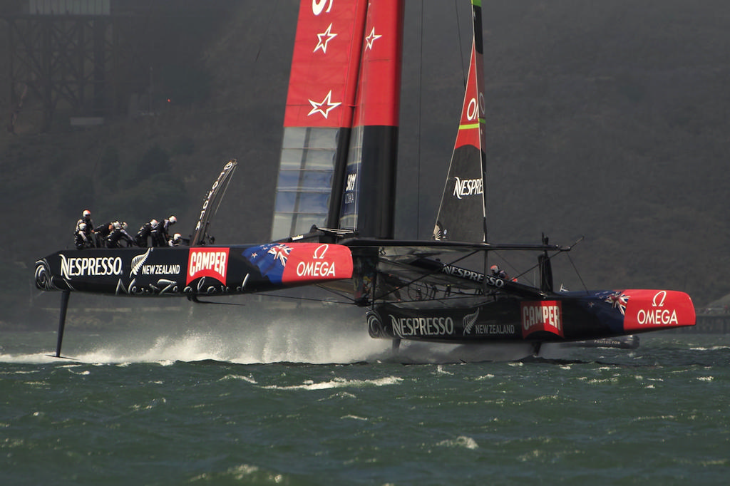 Emirates Team NZ at speed, downwind, one daggerboard up.  - America’s Cup © Chuck Lantz http://www.ChuckLantz.com