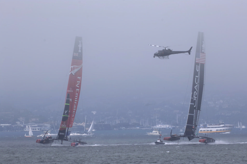 Emirates Team New Zealand and Oracle Team USA with chopper on watch - America&rsquo;s Cup, day 2 photo copyright Chuck Lantz http://www.ChuckLantz.com taken at  and featuring the  class