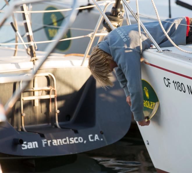 Crew member applies Rolex bow sticker the day before racing starts ©  Rolex/Daniel Forster http://www.regattanews.com