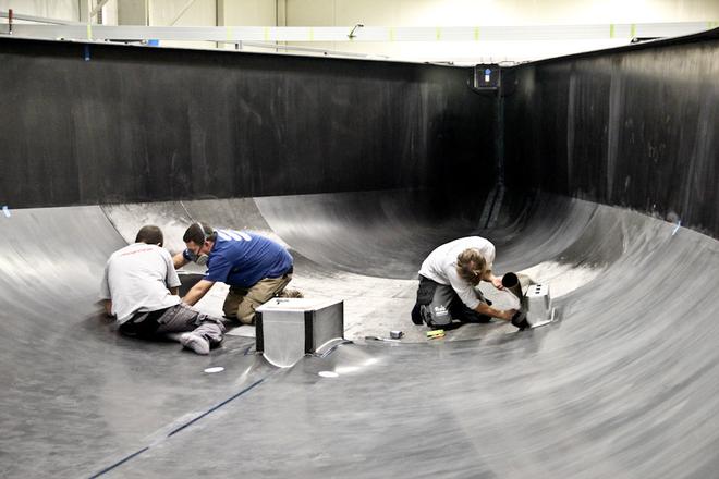 Boat builders laminate carbon to create the outside layer of the hull thanks to a 12.5mm-thick mould. Once completed, the hull is cooked at 90° C for about seven hours. A sudden change in temperature could damage the hull.  - Volvo Ocean Race 2014-15 © Mark Somerville/Persico Marine