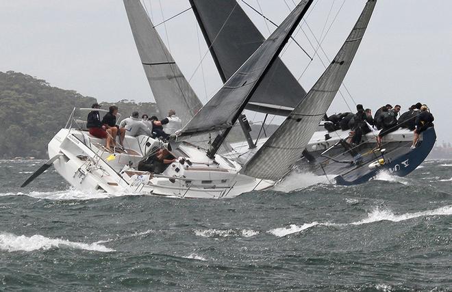 Mixing fleets; Shogun V crosses tacks with an entry in the Beneteau Cup © Dale Lorimer