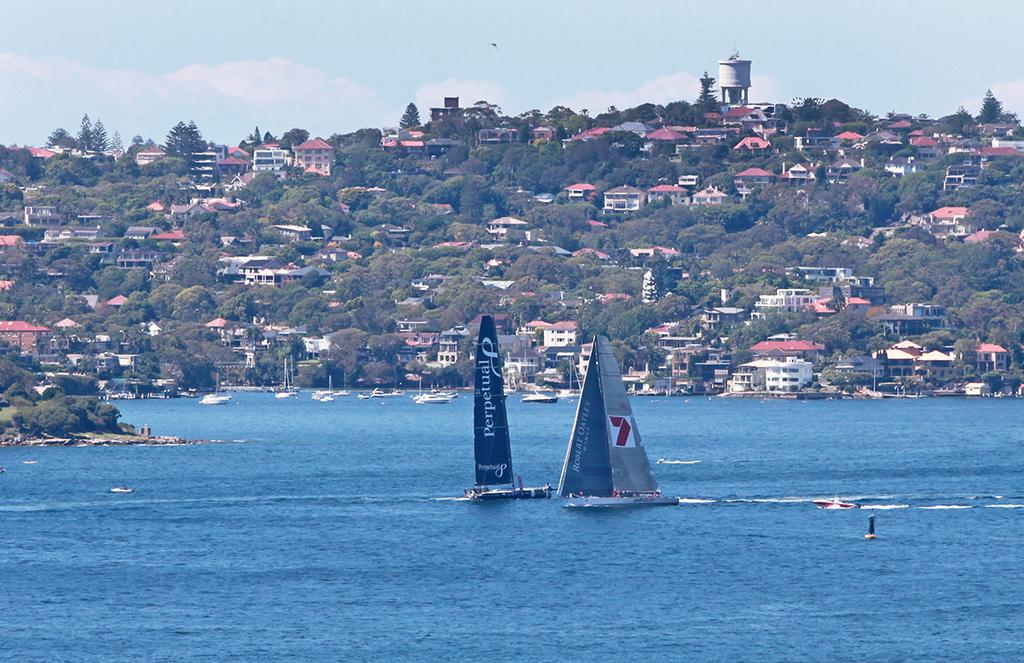 Wild Oats XI heads down the harbour passing Perpetual Loyal returning from a night at sea. © Crosbie Lorimer http://www.crosbielorimer.com