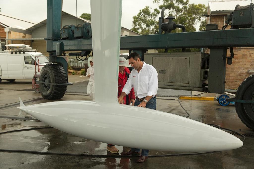 Close inspection: Wild Oats XI’s skipper, Mark Richards, checks the yacht’s 12-tonne ballast bulb which is fitted to the canting keel. The yacht is out of the water this week for a final pre-race inspection - Rolex Sydney to Hobart 2013 © Andrea Francolini