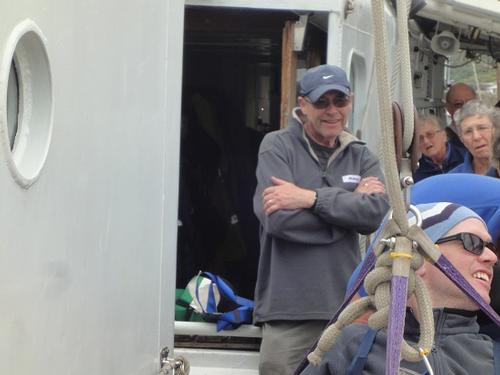 2. Andy ascends. Father Allen watches with intense curiosity. - Disabled Tall Ship sailing - Lord Nelson - Image: Philippa Williams © SW