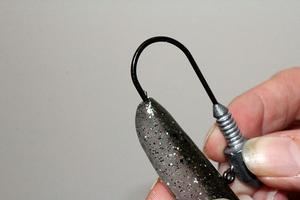 Leaving your thumb and forefinger in the position of where the hook will push through the plastics body, take the jig head and enter the hooks point in the center of the nose. photo copyright Jarrod Day taken at  and featuring the  class