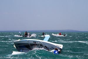 Many that righted their capsized craft just watched roll over once more and then once more again.... photo copyright  Alex McKinnon Photography http://www.alexmckinnonphotography.com taken at  and featuring the  class