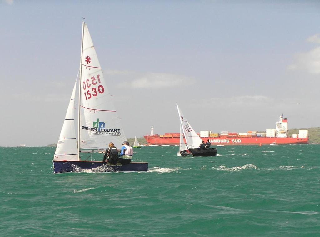 Brett & Penny Linton, sailing #1530 ``Rhythm & Swing`` and Jake & Ben Hawker sailing #1322 ``Embers`` in the invitation race that Brett eventually won. The race area is to the Southwest of the shipping channel between NarrowNeck Beach and Rangitoto Island. - 2014 Sunburst Nationals photo copyright Nigel Price taken at  and featuring the  class