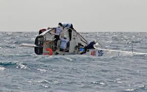  J/24 Island Water World Die Hard crew struggle to right the boat after a capsize in today’s windy race. - Mount Gay Round Barbados Race Series 2014 photo copyright Peter Marshall taken at  and featuring the  class