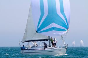 Instant Karma under kite on her way to winning Division Blue for the day. - Club Marine Series photo copyright Teri Dodds http://www.teridodds.com taken at  and featuring the  class