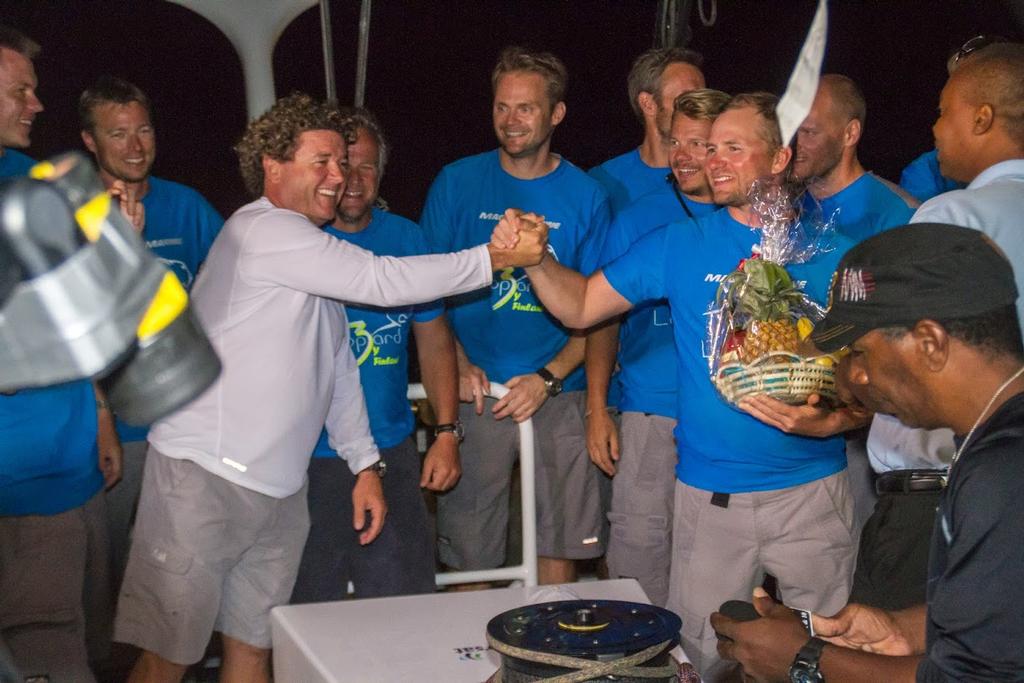ARC 2014 - Skipper Chris Sherlock and Leopard by Finland Project Manager Samuli Liesti are presented with a basket of Saint Lucian produce and congratulate each other on the record breaking crossing.  © WCC / Joao Buraca