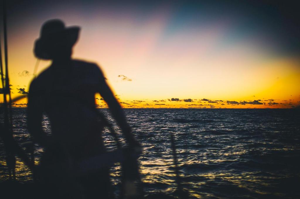 December 4, 2014. Leg 2 onboard Team Alvimedica. DAY 15. The fleet begins to converge as the exclusion zone enters the picture. Charlie Enright steering into the night--the most comfortable time of day on deck in the extreme heat of the middle latitudes. photo copyright  Amory Ross / Team Alvimedica taken at  and featuring the  class
