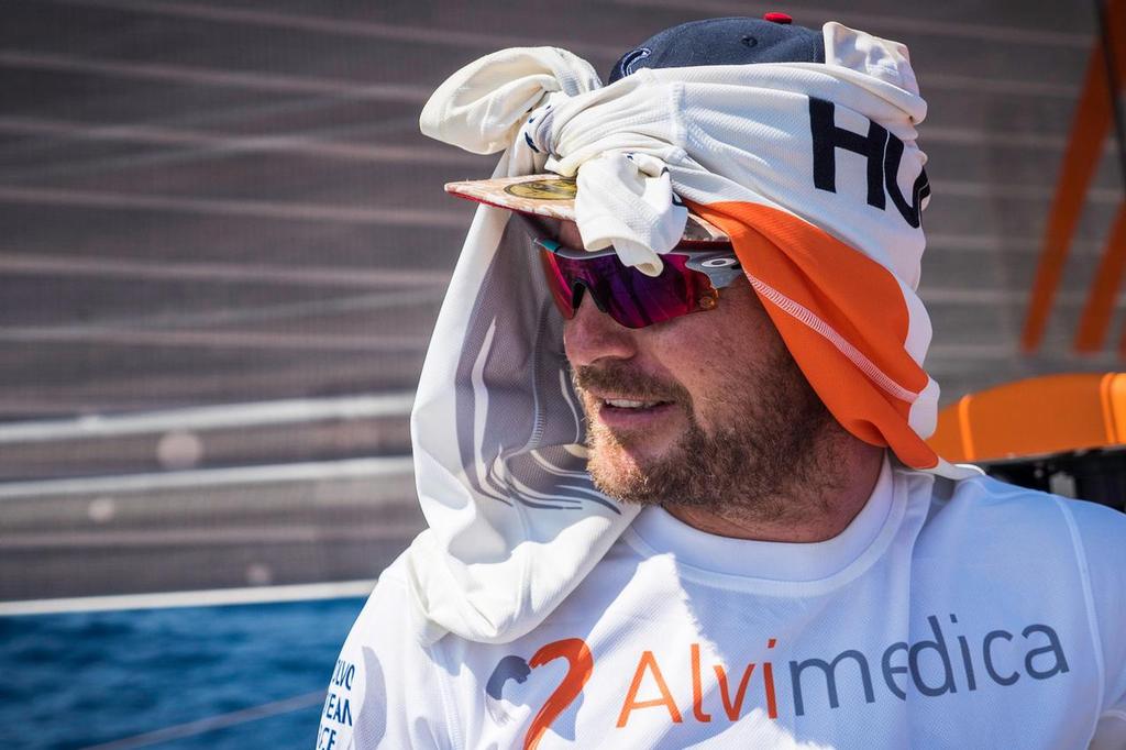 December 8, 2014. Leg 2 onboard Team Alvimedica. DAY 19. Not entirely free of the doldrums, the northerly sailing continues but not without it's sweltering heat and the occasional park-up. Ryan Houston ties his own sun solution, full coverage but foul smelling. ©  Amory Ross / Team Alvimedica