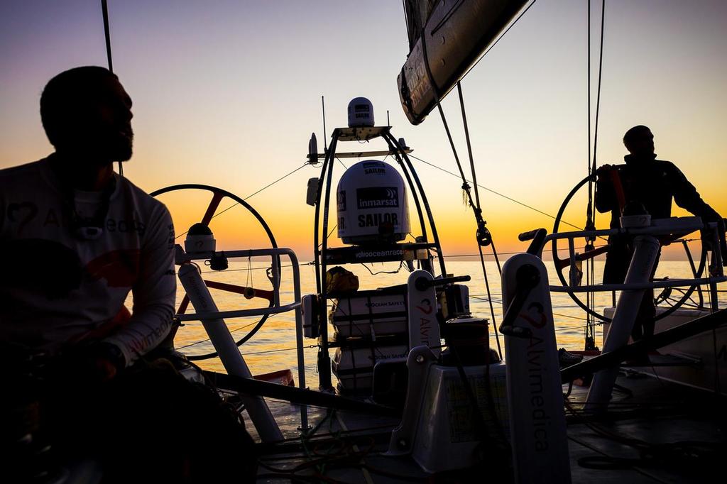 December 12, 2014. Leg 2 onboard Team Alvimedica. DAY 23. A windless morning and variable land and sea breezes in the forecast, it will be a long day of sailing through the Gulf of Oman towards the Straits of Hormuz, trying to hold MAPFRE at bay--just 9 miles astern. ©  Amory Ross / Team Alvimedica
