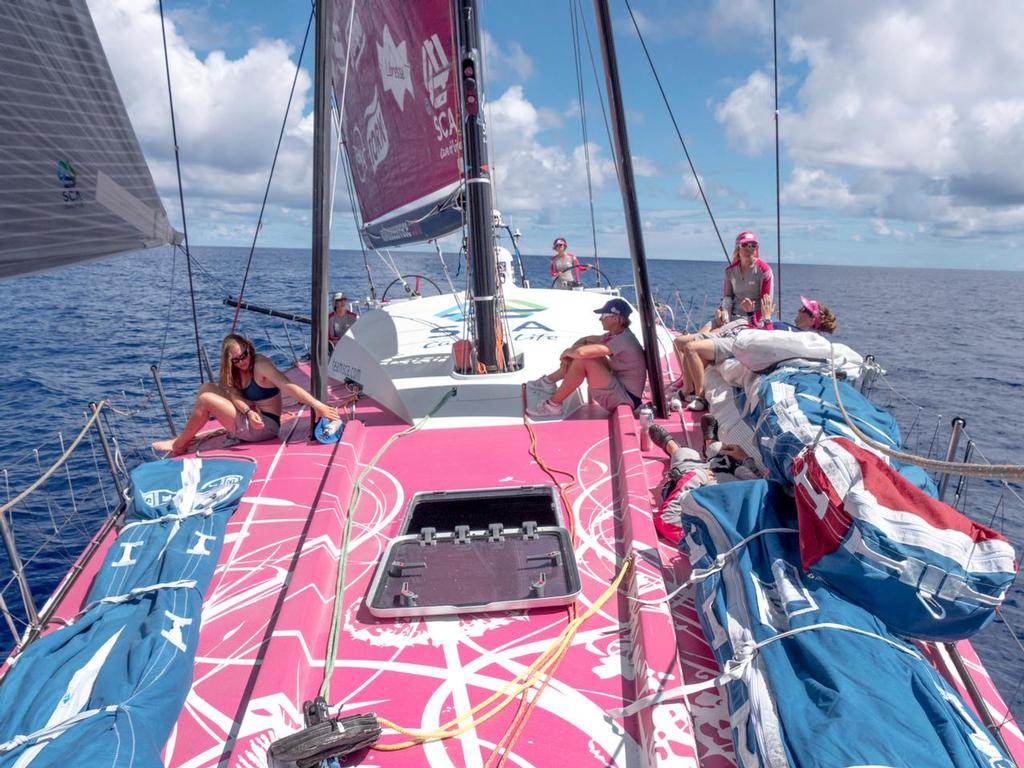 December 3, 2014. Leg 2 onboard Team SCA. Everyone on watch attempting to hide in the shade on the fordeck because of light winds. © Corinna Halloran / Team SCA