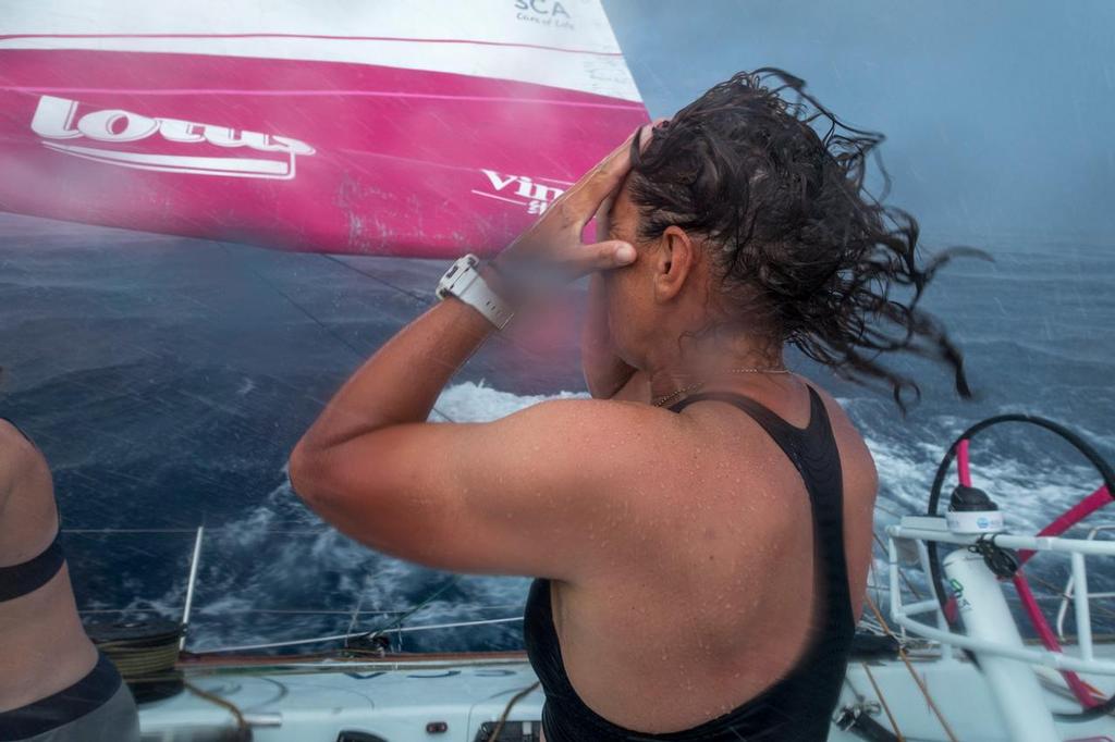 December 05, 2014. Leg 2 onboard Team SCA. Dee washes her hair in a squall. © Corinna Halloran / Team SCA