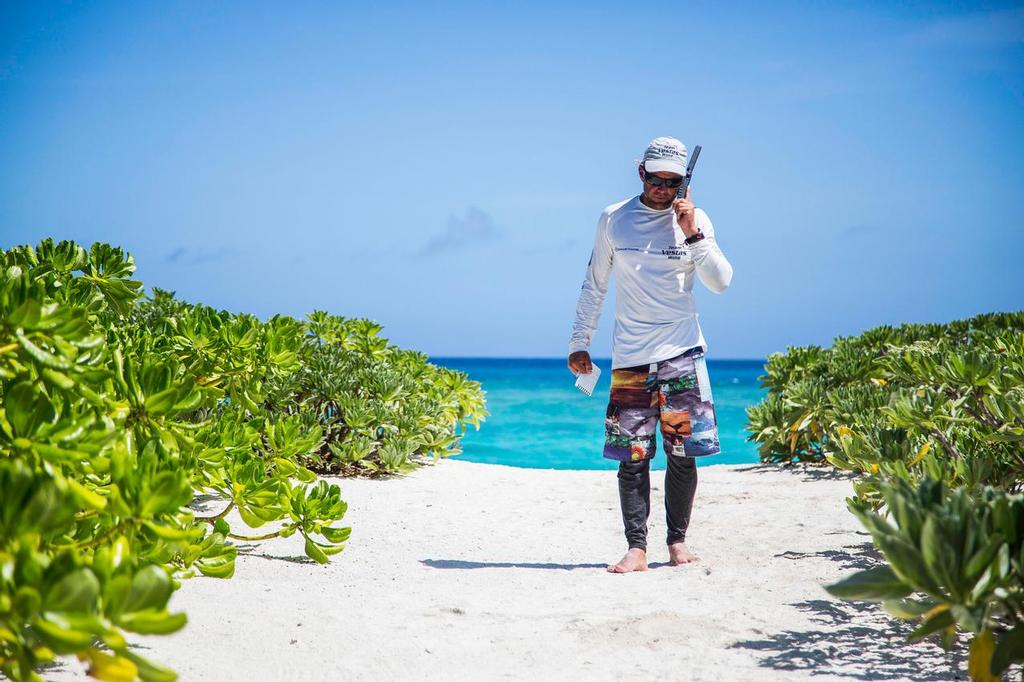 Team Vestas Wind’s boat grounded on the Cargados Carajos Shoals, Mauritius, in the Indian Ocean.  Chris Nicholson uses the satellite phone to call the shore crew on Mauritius. © Brian Carlin - Team Vestas Wind