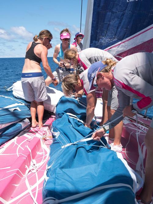 December 04, 2014. Leg 2 onboard Team SCA.The girls pack away the A3 on the foredeck. © Corinna Halloran / Team SCA