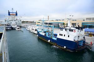 DYT Yacht Transport’s Yacht Express submerges in Port Everglades, Fla. to allow its cargo of yachts, including the 126-foot research vessel M/V Ocearch (blue hull), to float on. Ocearch is on its way to Brisbane, Australia. photo copyright Tom Serio Photography taken at  and featuring the  class