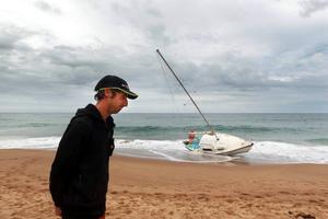 Damien Smith, owner of the yacht, at Stanwell Park Beach on Sunday. photo copyright Sylvia Liber taken at  and featuring the  class