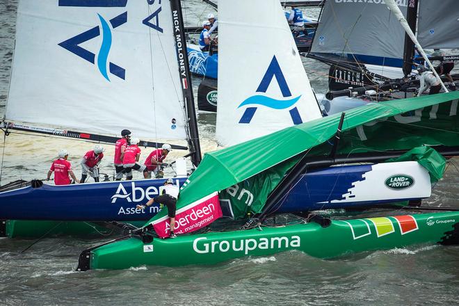 Team Aberdeen Singapore caught the biggest gust of the day as they came into the finish line struggling to hold off the pace, ploughing into the back of the French Groupama sailing team. - Extreme Sailing Series™ 2014 © Lloyd Images