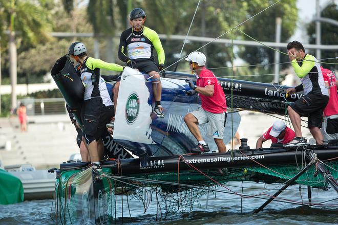 The teams assess the damage after the collision. - Extreme Sailing Series™ 2014 © Lloyd Images