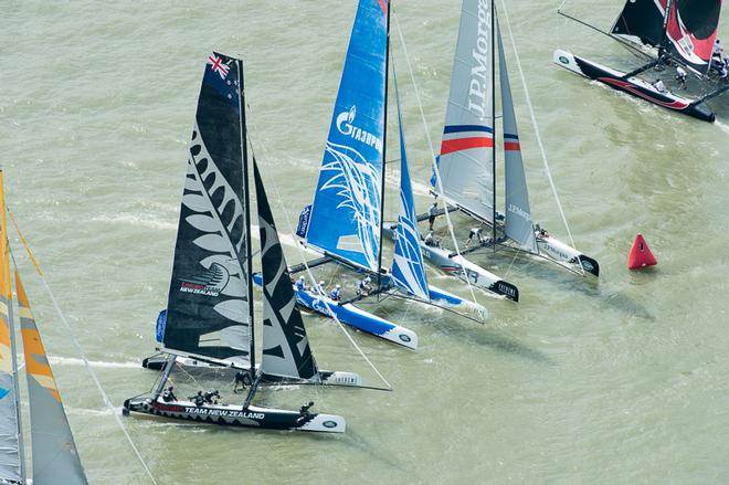 Emirates Team New Zealand, Gazprom Team Russia and JP Morgan jockey for position at the top mark. Day four of the Extreme Sailing Series regatta being sailed in Singapore. 23/2/2014 © Chris Cameron/ETNZ http://www.chriscameron.co.nz