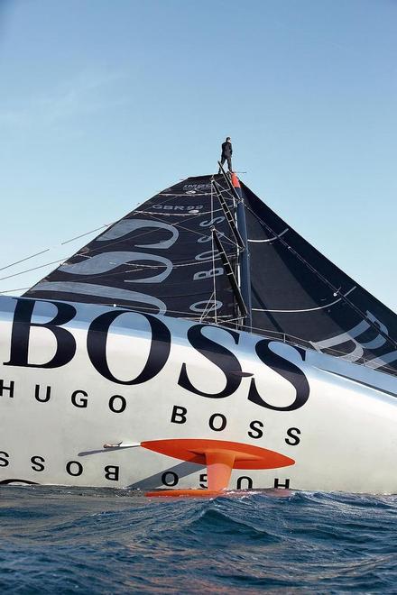 Pictures of Alex Thomson the skipper of the Hugo Boss IMOCA Open 60 race yacht walking up the mast of his yacht whilst sailing. © Lloyd Images/Alex Thomson Racing