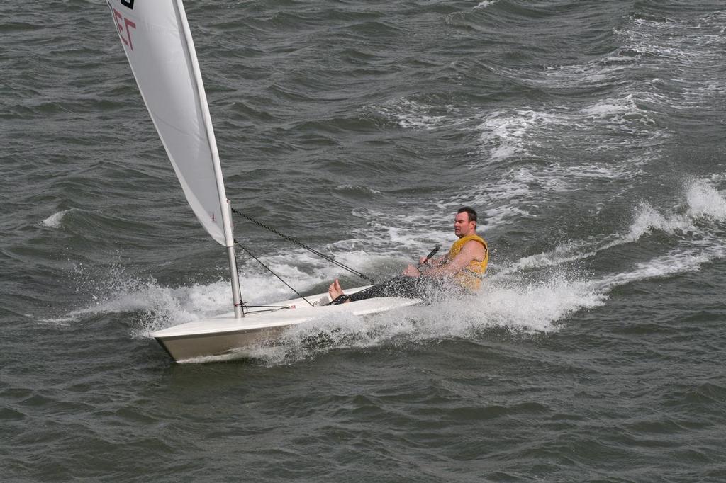 Wet R's skippered by Ross Gage flying downwind in front of the Lane Cove Clubhouse - NSW Metropolitan Championships Laser Sailing Coimes to Lane Cove Sailing Club photo copyright Rolf Lunsmann taken at  and featuring the  class