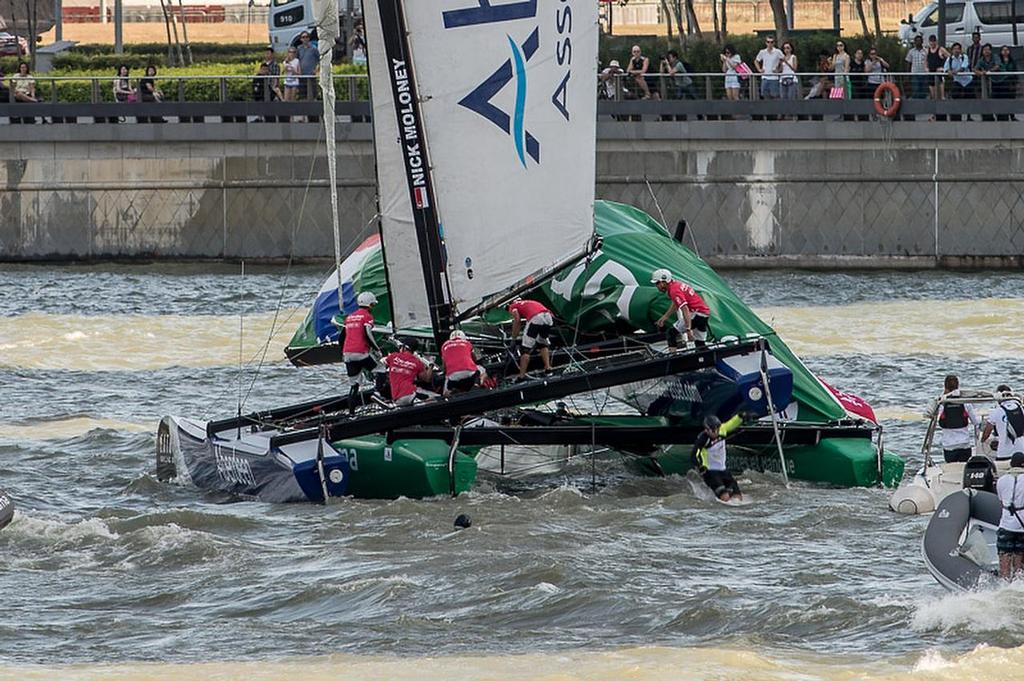 Team Aberdeen Singapore crashes down onto Groupama taking down the rig and injuring sailor Tanguy Cariou. Day three of the Extreme Sailing Series regatta being sailed in Singapore. 22/2/2014 photo copyright Chris Cameron/ETNZ http://www.chriscameron.co.nz taken at  and featuring the  class