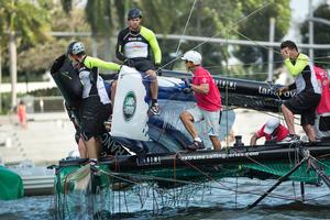 The teams assess the damage after the collision. - Extreme Sailing Series™ 2014 photo copyright Lloyd Images taken at  and featuring the  class