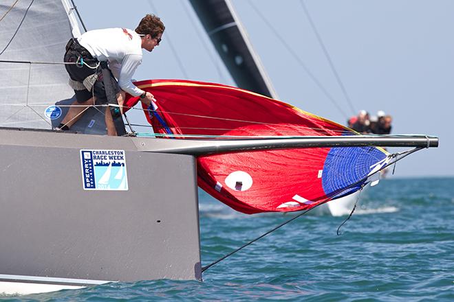 A bowman on the fastest boat on the course - the 47-foot GrunDOOM - hauls the spinnake to the bow to prepare for a hoist at 2014 Sperry Top-Sider Charleston Race Week. © Meredith Block/ Charleston Race Week http://www.charlestonraceweek.com/